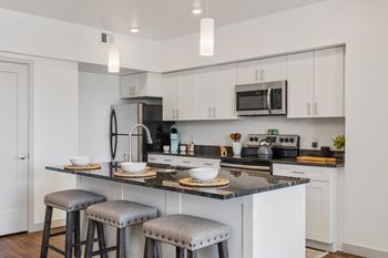 Kitchen with white cabinetry and modern appliances